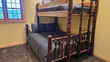 A bunk bed with a ladder, a window, and a carpeted floor.