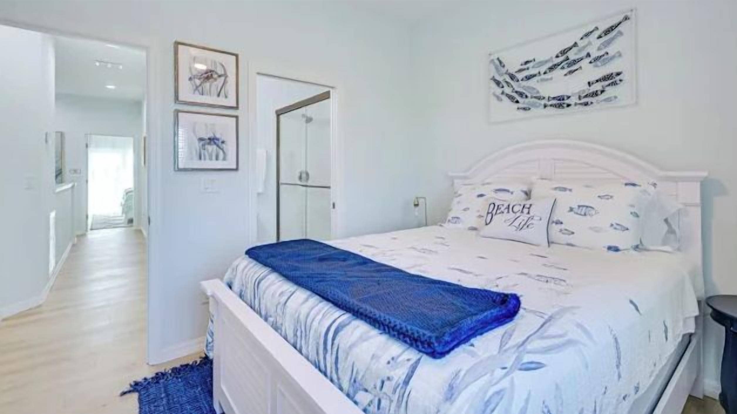 A bedroom with a bed, a door, and a wall with text.