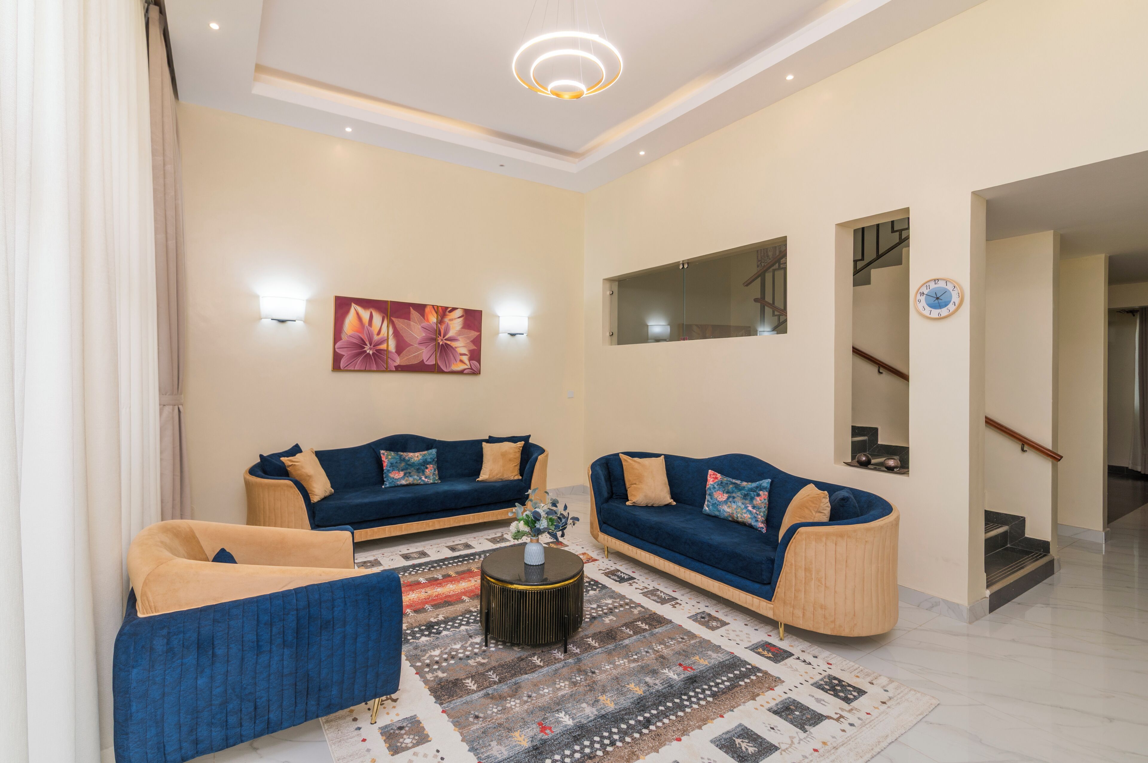 A living room with two sofas, a coffee table, and a patterned rug.