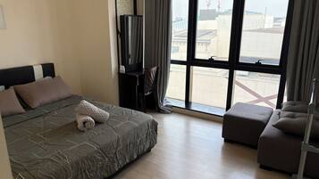 Deluxe Studio | Desk, laptop workspace, blackout curtains, soundproofing