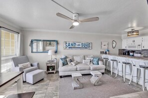 Bright coastal living room with open kitchen and spacious breakfast bar - Ocean Front Condo - 2 pools hot tub Cruise Parking on seawall babes beach (Galveston)