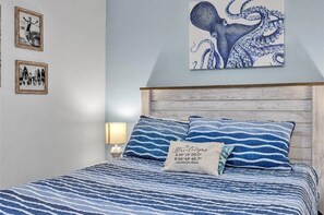 Coastal-inspired bedroom with wave linens and charming nautical decor - Ocean Front Condo - 2 pools hot tub Cruise Parking on seawall babes beach (Galveston)
