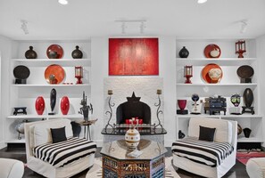 A living room with two sofas, a coffee table, and a fireplace. - Modern Cottage Overlooking Sheepscot River (Boothbay)