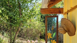 A wooden structure with a glass door featuring a painted iris flower design.
