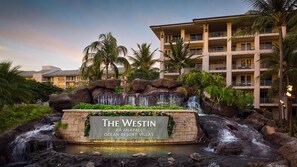 Un complexe hôtelier doté d’une cascade, de palmiers et d’un panneau indiquant « The Westin Kaanapali Ocean Resort Villas ».