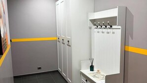 A modern bathroom with a white vanity, a mirror with a towel rack, and a tiled floor. - Apartment located in a prime location in Ostia Lido (Lido di Ostia)