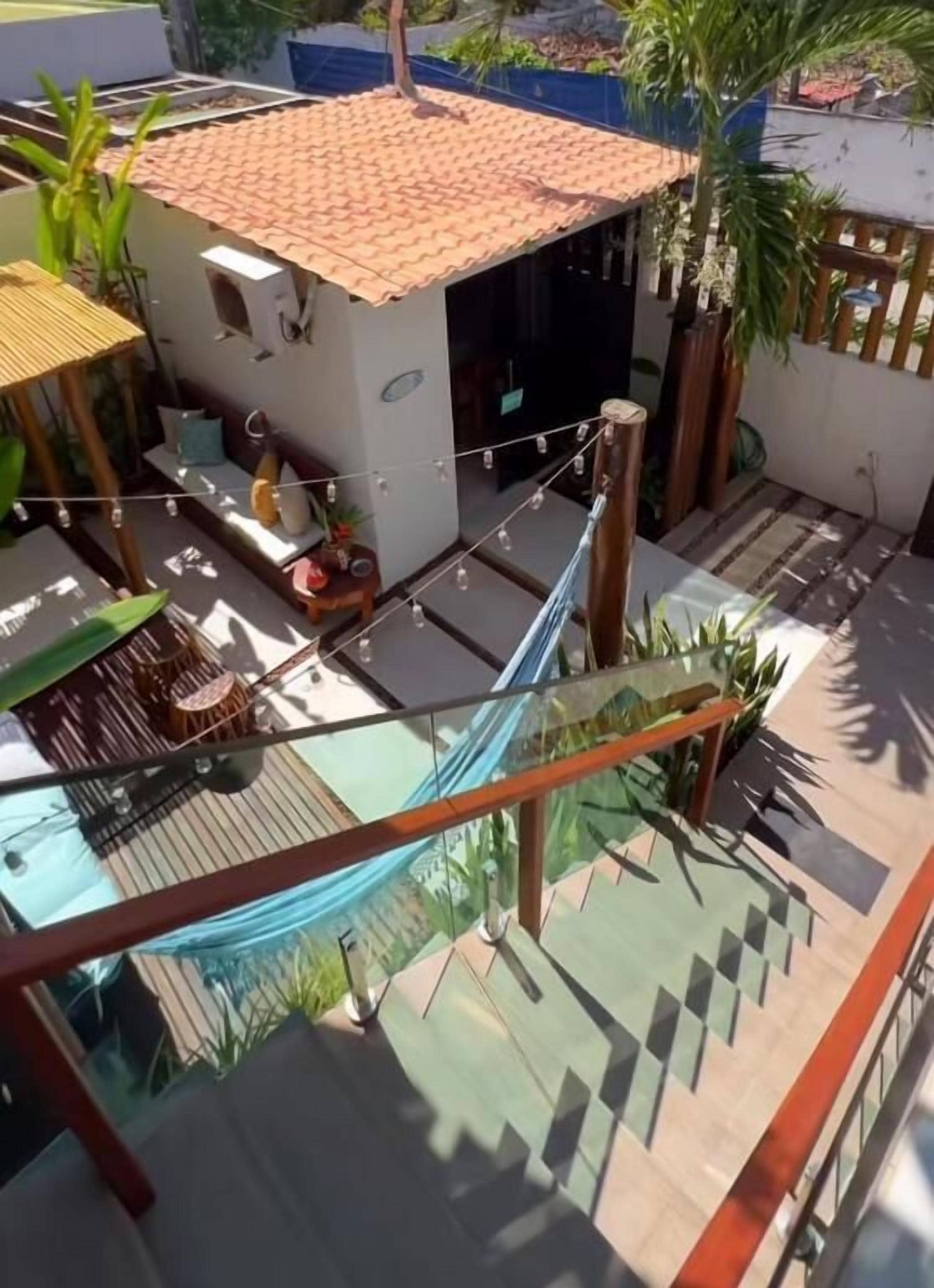 A residential area with a small house, a hammock, and a staircase.