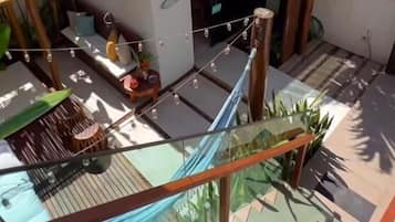 A residential area with a small house, a hammock, and a staircase.
