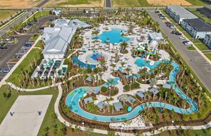 An aerial view of a resort with a large central pool, multiple smaller pools, and a water park area. - 8BR house with private pool and game room (Clermont)