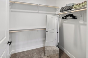 A walk-in closet with open doors, shelves, and hanging space. - Escape To The Sage Room 2 BR Suite Tempe Town Lake (Tempe)