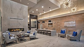 A modern living room with a fireplace, seating area, and a dining setup. - Escape To N. Scottsdale 2BR Saguaro Cactus Retreat (Phoenix)