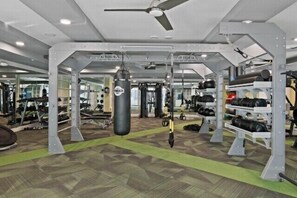 A gym with weightlifting equipment, cardio machines, and a punching bag. - Escape To N. Scottsdale Modern & Chic 1BR Suite (Phoenix)