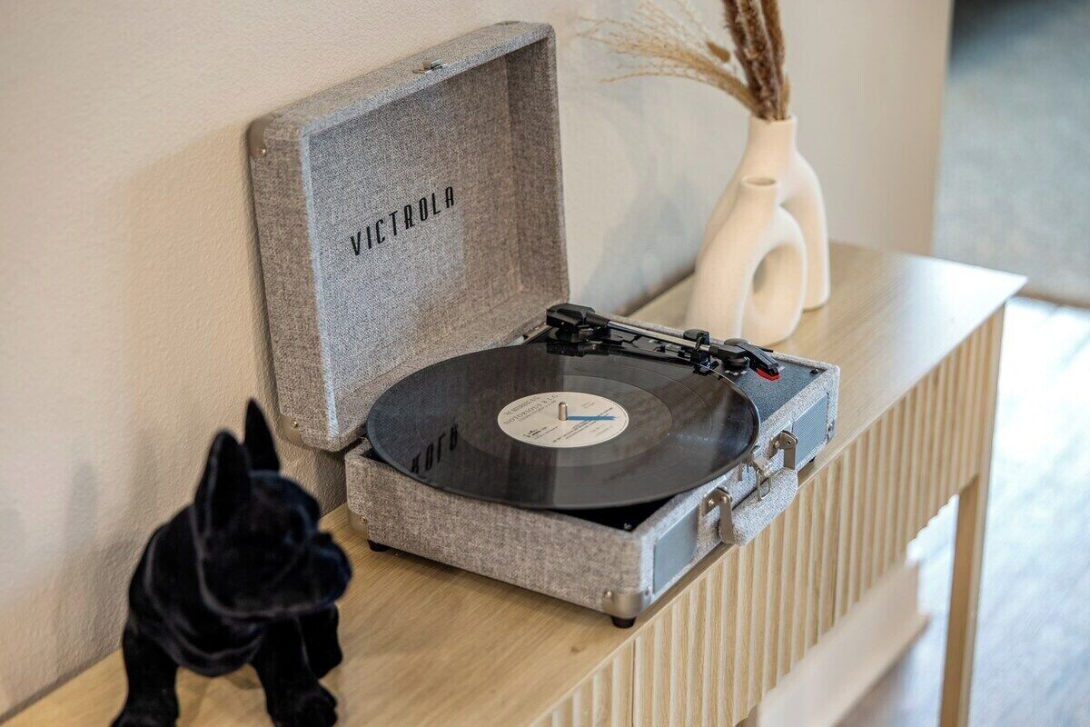 A turntable with a record inside, placed on a wooden surface.