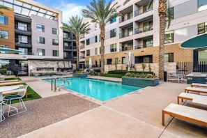 A modern hotel with a swimming pool, outdoor seating, and palm trees. - Escape To Poolside Bohemian Desert King Bed Studio (Tempe)