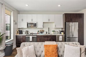 A modern kitchen with white cabinets, a stainless steel refrigerator, and a microwave. - Escape To Tempe Town Lake Golden Dream Studio (Tempe)