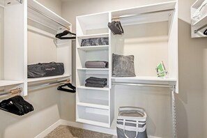 A walk-in closet with open shelving, hanging space, and a storage bin. - Escape To Hollywood Hideaway 2BR King Bed Suite (Phoenix)