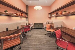 A conference room with a long table, six chairs, and shelving with potted plants. - Escape To The Tempe Penthouse King Bed Studio (Tempe)