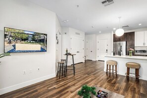 A modern kitchen with white cabinetry, a stainless steel refrigerator, and a built-in oven. - Escape to Luxurious & Modern 1 BR Tempe Town Lake (Tempe)