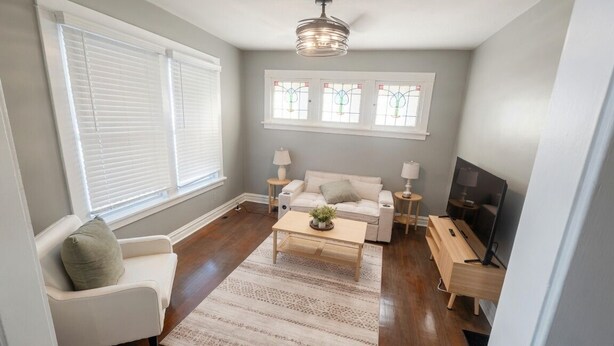 A living room with a sofa, coffee table, and TV stand.