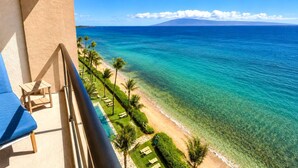 A balcony with a view of a beach and ocean. - Mahana Resort | Oceanfront Studio Sleeps 2 | Car Incl. w/ 6+ Nights | MAH-1002 by KBM (Lahaina)