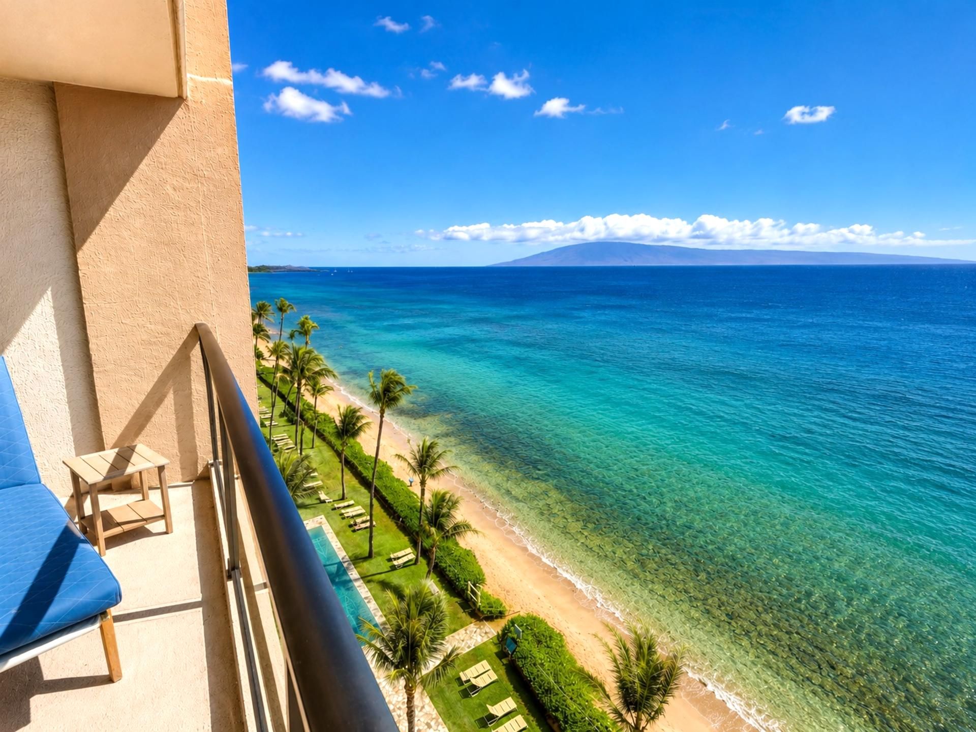 A balcony with a view of a beach and ocean.