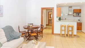 A compact living space with a dining area, kitchenette, and a sofa. - SunDream Apart II (Funchal)