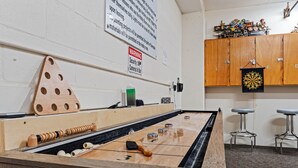 A billiards table with a wooden triangle rack, cue sticks, and numbered balls. - Oceanfront 3BR Balcony Indoor Outdoor Pools (Daytona Beach Shores)