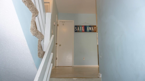 A staircase with a 'SAIL AWAY' sign, a white door, and a light blue wall. - Beachfront Villa With Sea Views Bikes Included Gulf Across St Kayak Access (Miramar Beach)