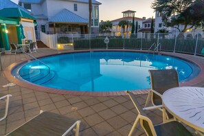 A swimming pool with a surrounding fence, lounge chairs, and a table. - Gated Beach Villa w 2 Pools 3 Bikes Included Tennis Pickleball Courts Included (Miramar Beach)