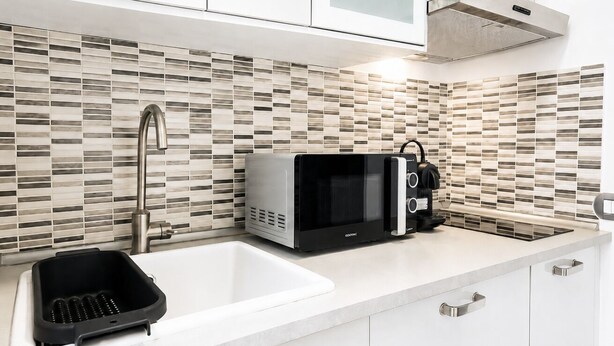 A kitchen with a microwave, toaster, and sink. - Elegantis Campo Marzio Apartment With Terrace | Spanish Steps, Trevi & Pantheon (Roma)