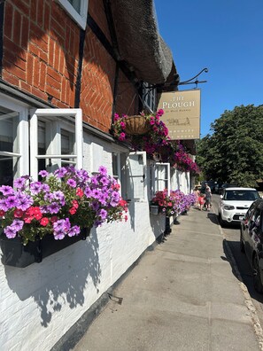 A building with a sign reading 'The Plough at West Hanney.'