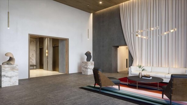 A modern lobby with a minimalist design, featuring a white sofa, a coffee table, and abstract sculptures. - near Bayfront Park Deluxe Room , Pet - friendly (Miami)