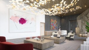 A modern interior with a large abstract painting, a colorful mural, and a unique ceiling light installation. - Deluxe 1BR near Bayfront Park &  Kaseya Center (Miami)