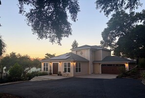 A two-story house with a garage, a covered porch, and a driveway. - Superb 3-bedroom home in peaceful Atascadero (Atascadero)