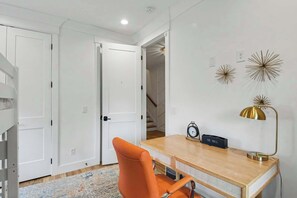 A room with a desk, chair, and a clock on the wall. - 4BR Escape for 12, East Nash Walkable Location! (Nashville)