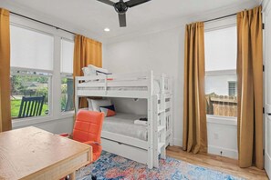 A bunk bed room with a desk and chair, large windows with curtains, and a ceiling fan. - 4BR Escape for 12, East Nash Walkable Location! (Nashville)