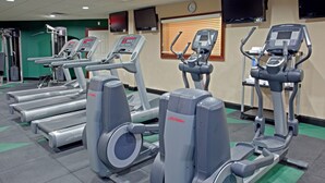 A gym with treadmills, ellipticals, and weight machines.