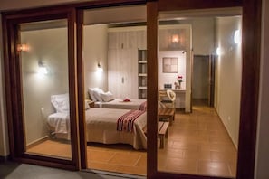 A room with two beds, a desk, and a chair.