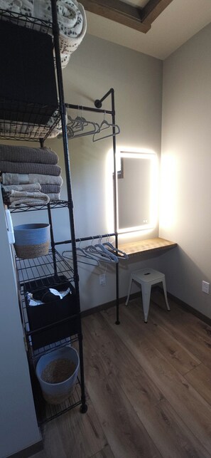 A bunk bed with a hanging rack, a small stool, and a window with a light. - Lakseside Lookout 3-bedroom cabin on Leech Lake (Walker)