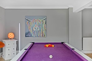 A room with a purple pool table, a white dresser, and a painting of a colorful animal on the wall. - Beautiful Secluded 2 Bedroom Coach House (Nottingham)