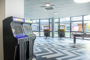 A gaming area with arcade machines and a pool table. - Brand New Spacious Studio in Beeston (Beeston)