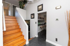 A staircase leading to a second floor with a plant on the landing. - East Abbotsford Spanish Villa (Abbotsford)