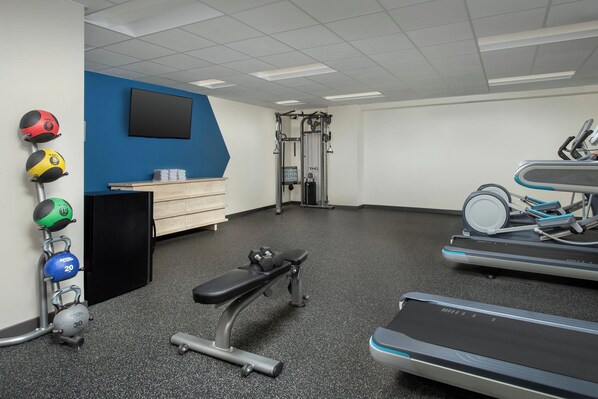 A gym with exercise equipment, a bench, and a treadmill. - Modern Stay in Downtown New Orleans Near the Quarter l 2 Units (New Orleans)
