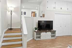 A staircase with wooden steps leading to a white door.