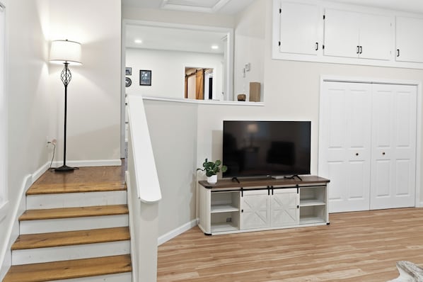 A staircase with wooden steps leading to a white door.