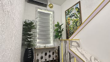 Uma escadaria com parede de mármore e chão de azulejos pretos.