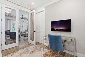 A modern interior with a desk, chair, and a painting of a night sky. - Kid-Friendly Bonita Home With Private Pool & Spa (Bonita Springs)
