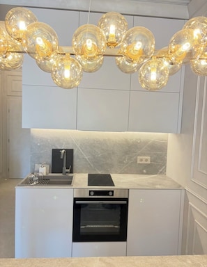 A modern kitchen with a built-in oven, a sink, and a countertop.