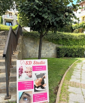 A signboard for SD Studio with visible services like manicure, pedicure, and hair treatment. - Stylish beach apartment near Kavatsi Beach, Sozopol (Sozopol)