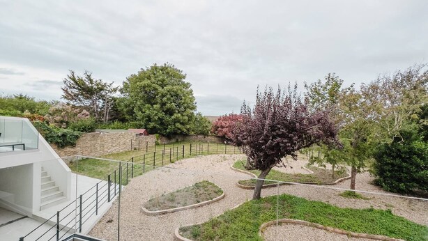 A landscaped outdoor area with a modern building, a staircase, and a variety of trees and shrubs. - Broadstairs 2 Bed Flat Balcony FT2 by Adliv (Broadstairs)